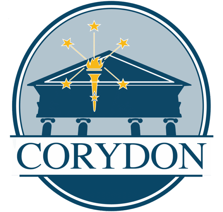 Circular blue seal featuring a classical temple with a vertical torch and stars above, and the word CORYDON on a white ribbon across the bottom.